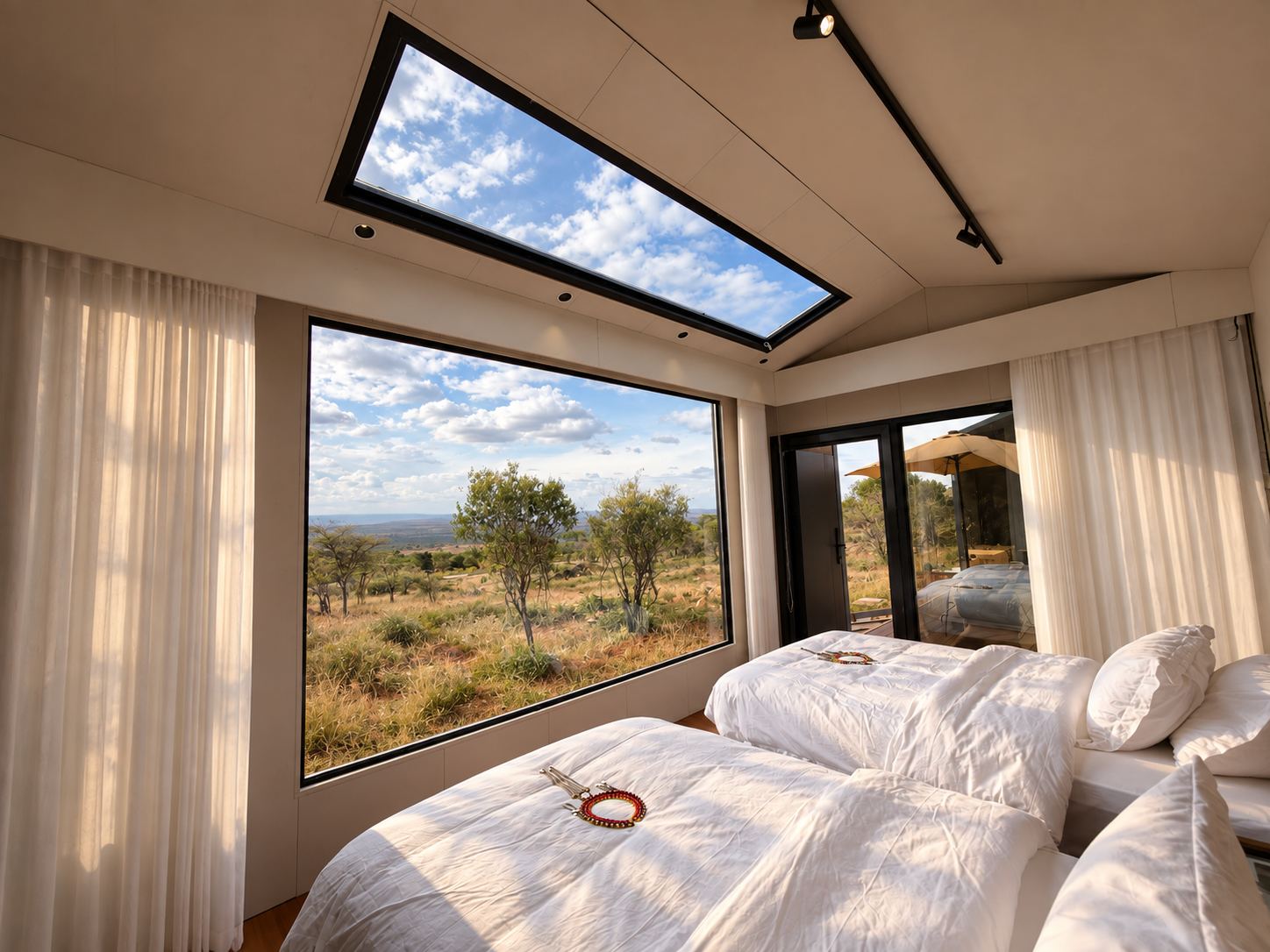 Savanna Cottage bedroom with a skylight and a window onto the bush
