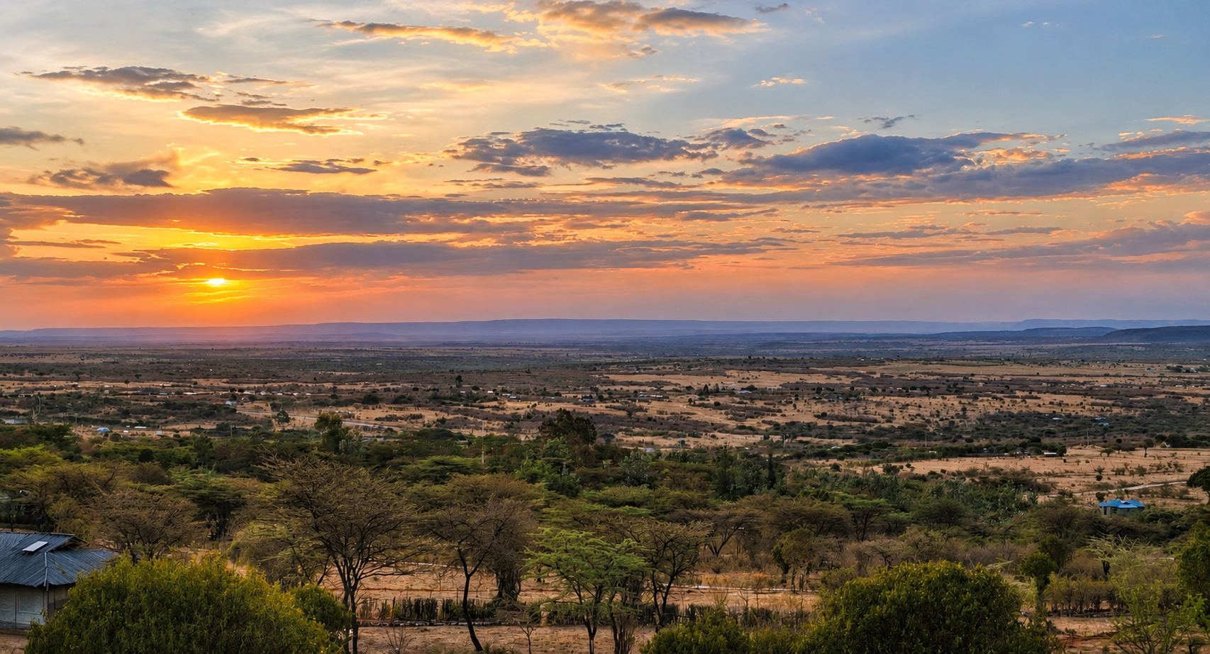 The Maasai Mara savanna at sunset, seen from camp