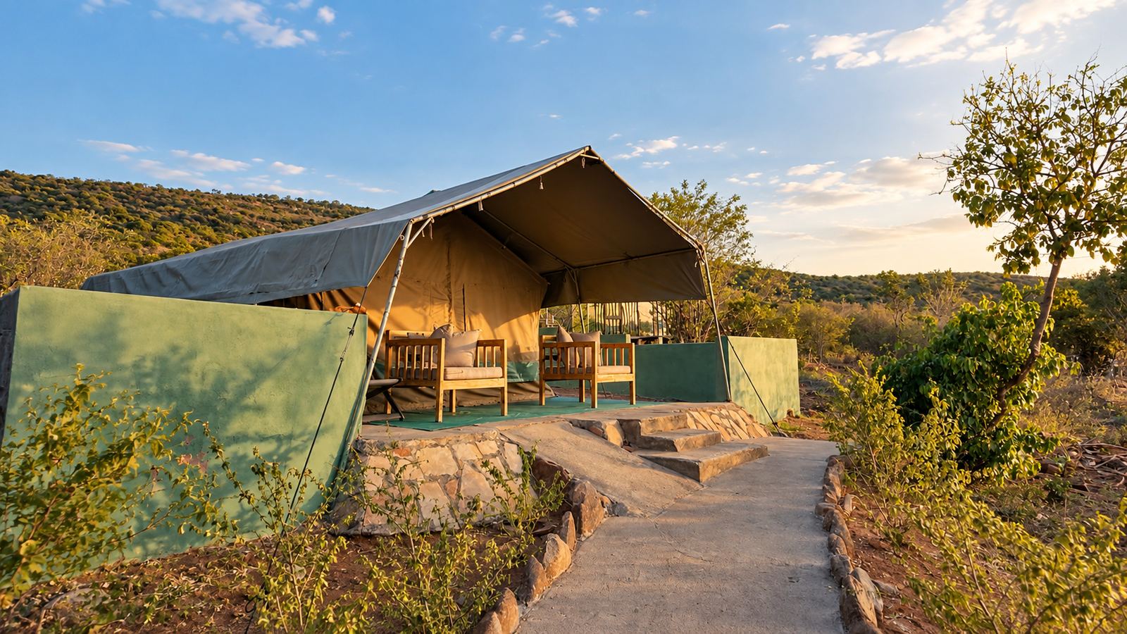 Canvas safari tent with a shaded veranda at Sausage Tree